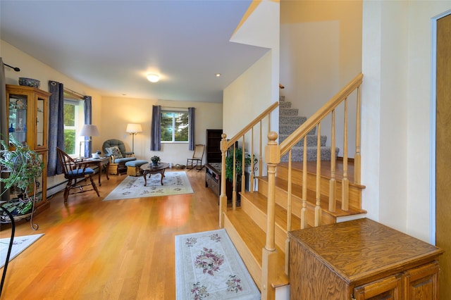 foyer with wood finished floors and stairs