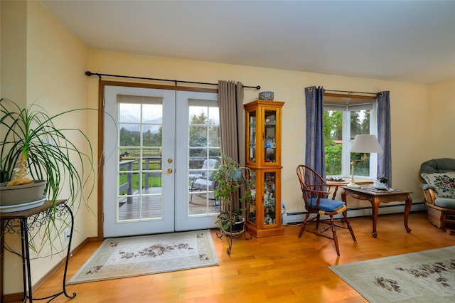 entryway with wood finished floors, french doors, and a baseboard radiator