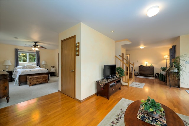 5400 Two Moons Rd, Florence, MT 59833 - living room featuring light wood-type flooring, stairs, ceiling fan, and baseboards
