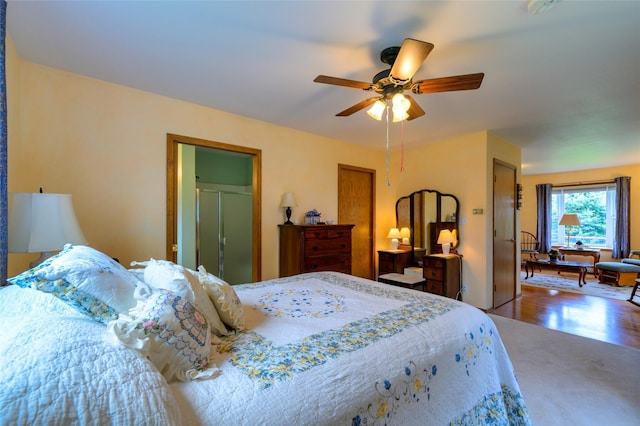 bedroom featuring wood finished floors and ceiling fan