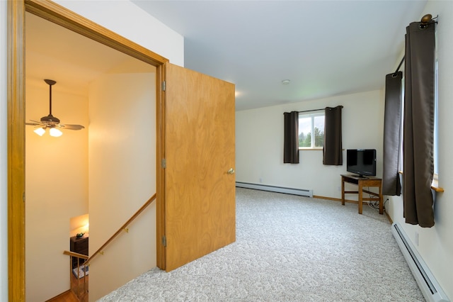 interior space featuring baseboard heating, carpet flooring, a ceiling fan, and a baseboard radiator