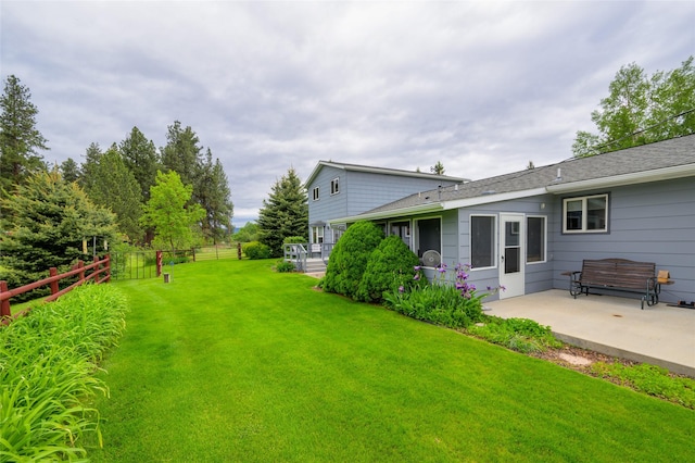 view of yard featuring a patio and fence