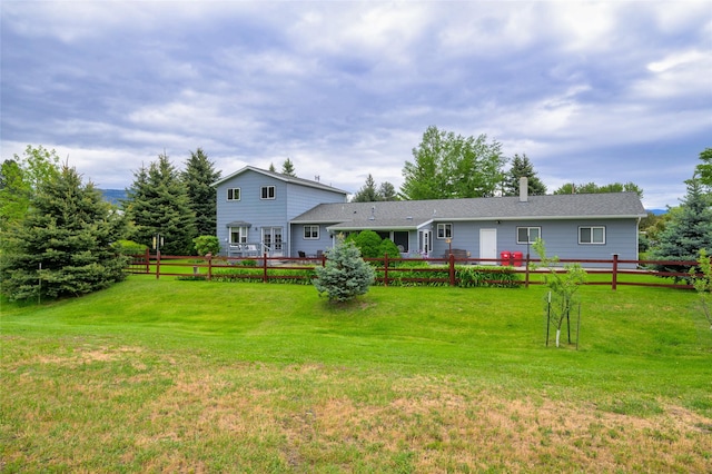 back of house with a yard and fence