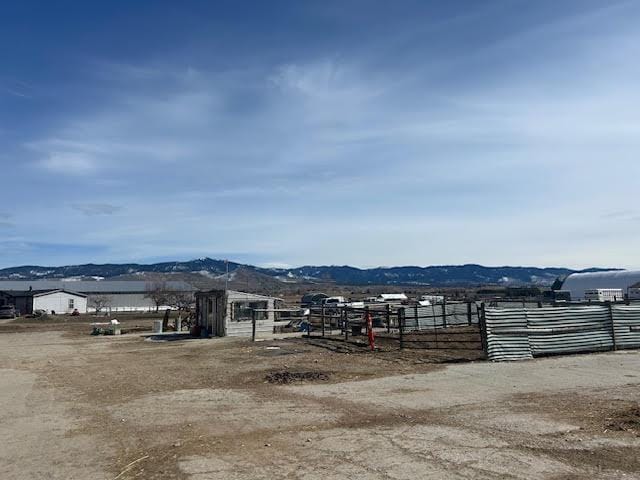 exterior space featuring fence and a mountain view