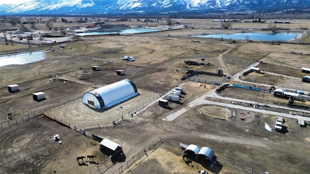 drone / aerial view with a water and mountain view