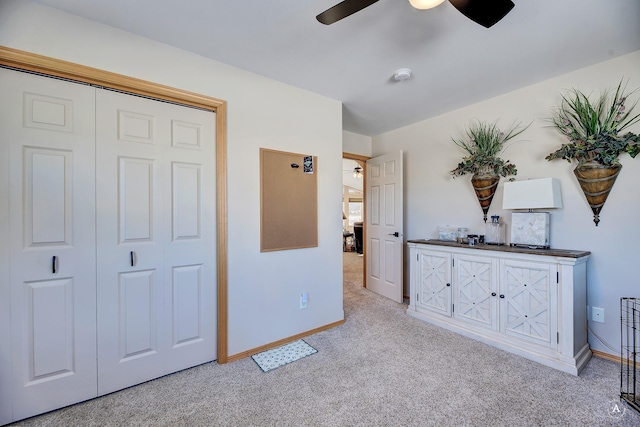 interior space featuring baseboards and ceiling fan