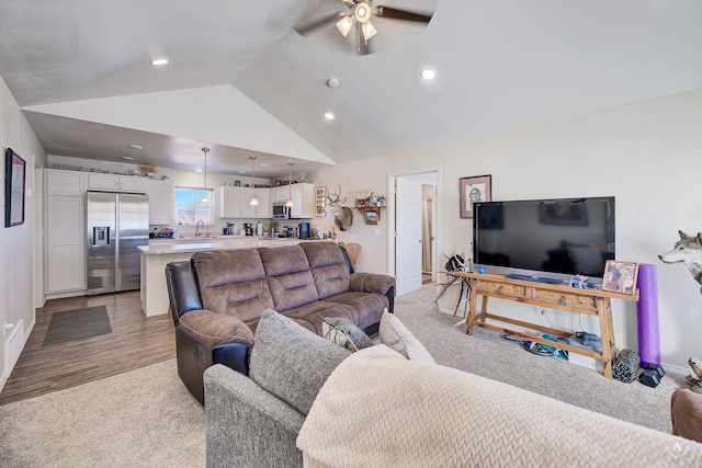 living area with lofted ceiling, recessed lighting, a ceiling fan, and light carpet