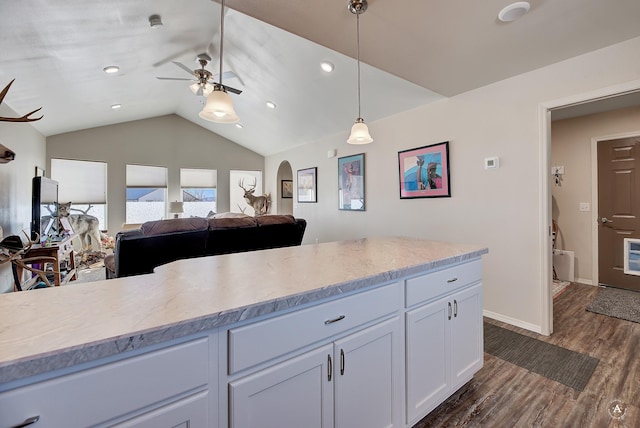 kitchen with decorative light fixtures, open floor plan, white cabinetry, lofted ceiling, and dark wood-style flooring