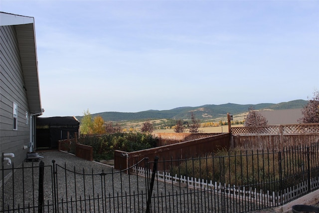 view of yard featuring a mountain view and a fenced backyard