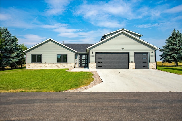 46361 Stagecoach Trl, Ronan, MT 59864 - view of front of home featuring an attached garage, driveway, a front yard, and stone siding