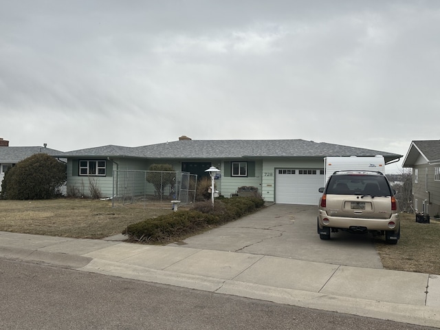 ranch-style home with driveway and a garage