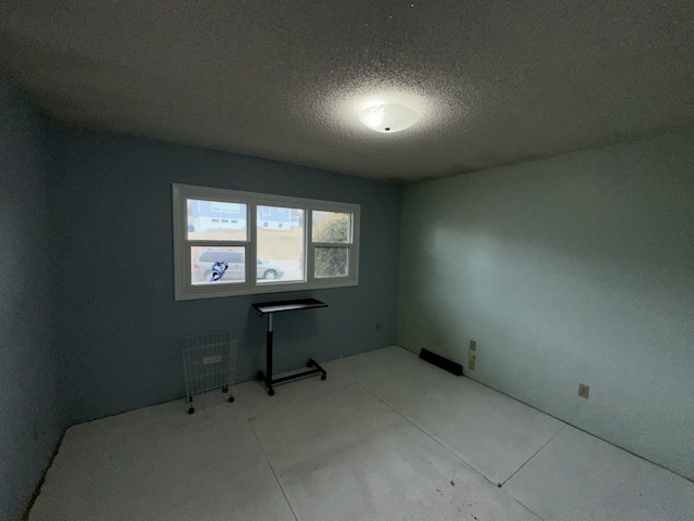 empty room featuring a textured ceiling