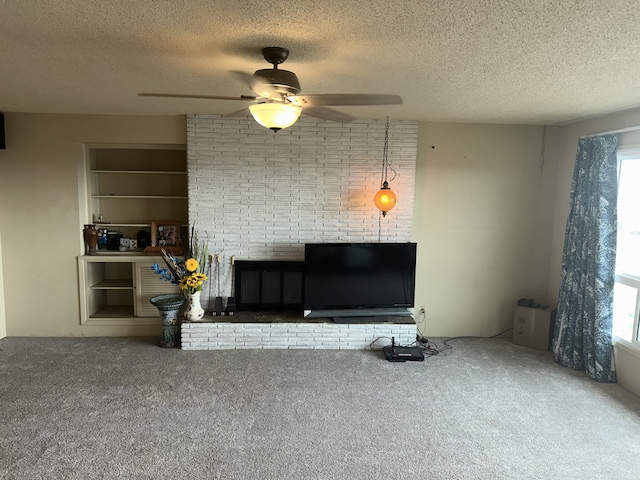 living area featuring a ceiling fan, carpet floors, and a textured ceiling