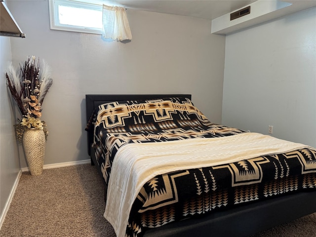 carpeted bedroom with visible vents and baseboards