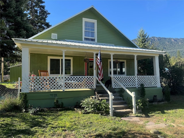 view of front facade featuring covered porch and metal roof