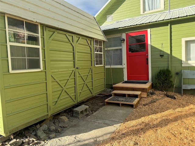 doorway to property featuring metal roof