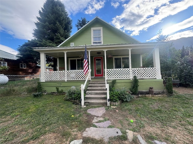 view of front of property with fence and covered porch