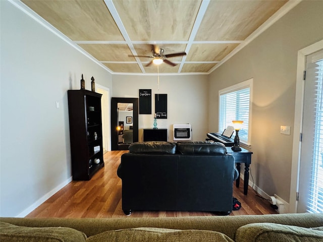 living area featuring heating unit, wood finished floors, baseboards, and coffered ceiling