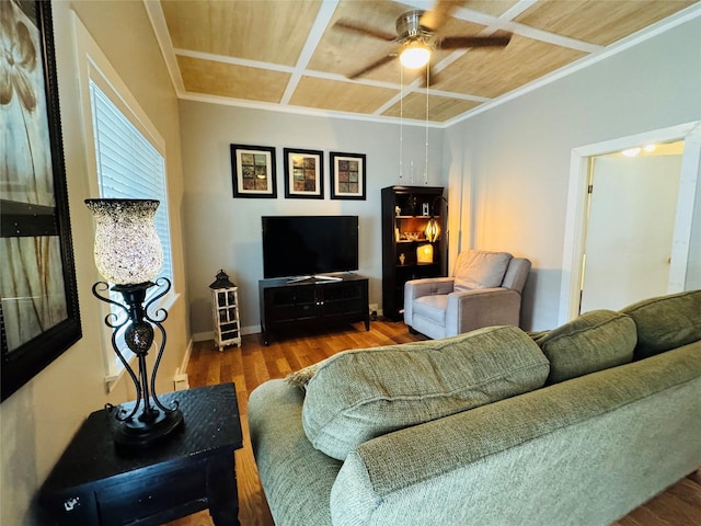 living room featuring wood finished floors, baseboards, coffered ceiling, ceiling fan, and crown molding