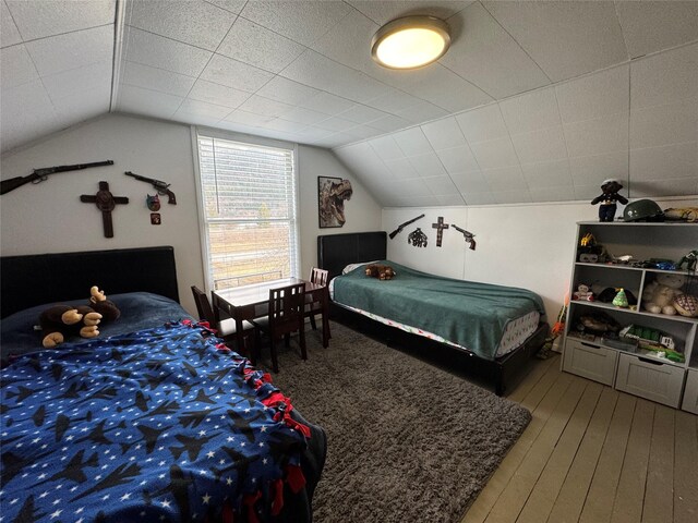 bedroom featuring vaulted ceiling and wood finished floors