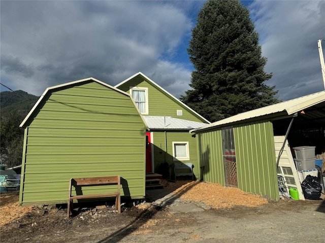 exterior space featuring metal roof and a gambrel roof