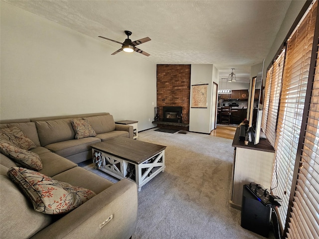 1103 Greers Ferry Rd, Libby, MT 59923 - carpeted living room featuring ceiling fan, a fireplace, and a textured ceiling