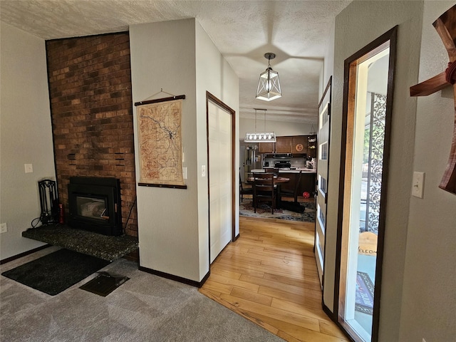1103 Greers Ferry Rd, Libby, MT 59923 - corridor with light wood-style floors, a textured ceiling, and baseboards
