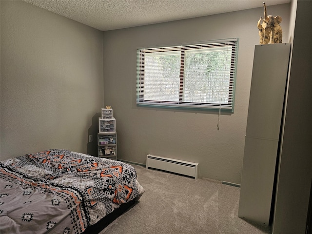 1103 Greers Ferry Rd, Libby, MT 59923 - carpeted bedroom featuring a baseboard radiator and a textured ceiling