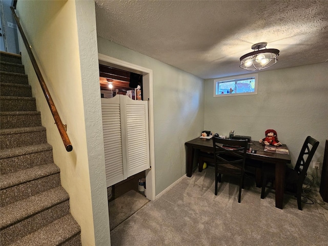 1103 Greers Ferry Rd, Libby, MT 59923 - carpeted dining room featuring a textured ceiling, stairway, and baseboards