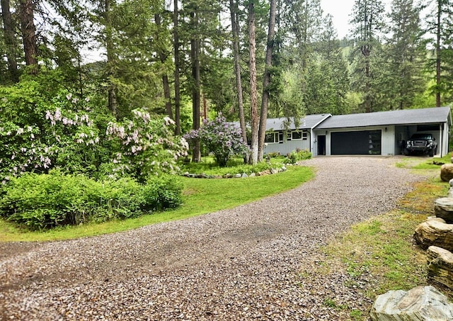 1103 Greers Ferry Rd, Libby, MT 59923 - view of front of home with gravel driveway and an attached garage