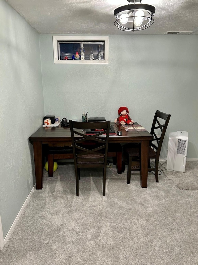 1103 Greers Ferry Rd, Libby, MT 59923 - dining space with carpet flooring, a textured wall, baseboards, and a textured ceiling