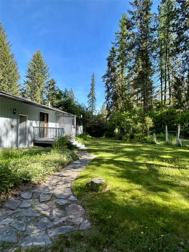 1103 Greers Ferry Rd, Libby, MT 59923 - view of grassy yard featuring a wooden deck