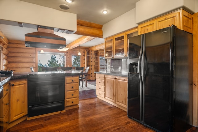 kitchen with dark countertops, black fridge with ice dispenser, dark wood-style flooring, and log walls