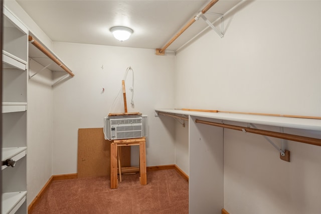 spacious closet featuring a wall unit AC and carpet