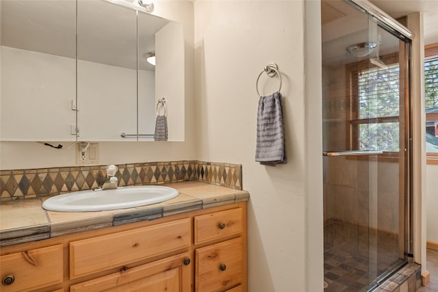 bathroom featuring vanity and a shower stall