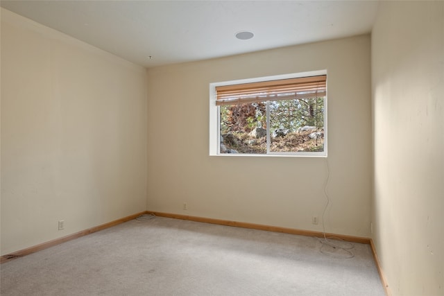 carpeted empty room with baseboards