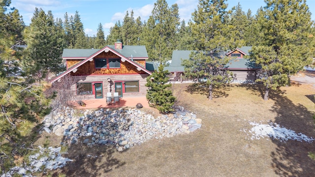 view of front of property featuring a chimney and a patio area