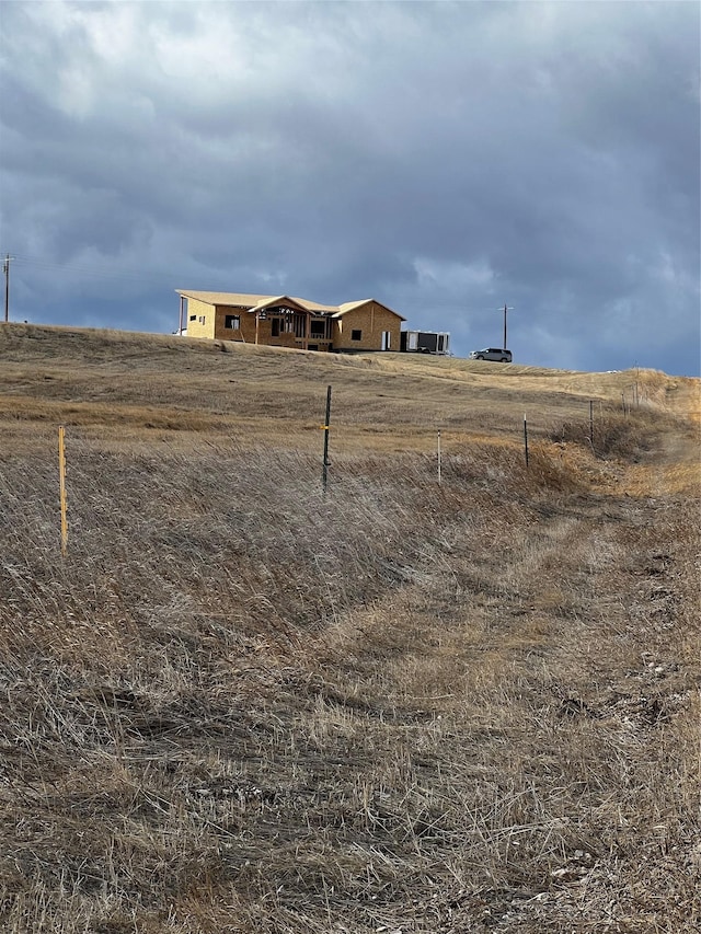 view of yard with a rural view