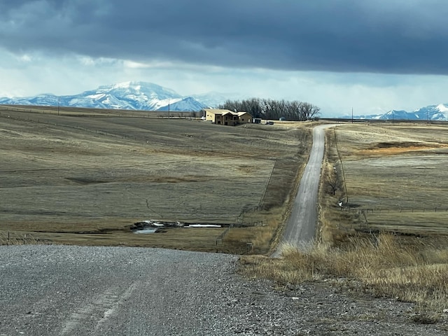 view of street with a rural view and a mountain view