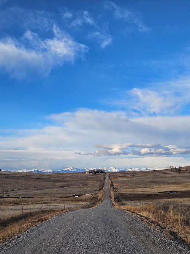 view of street with a rural view and a mountain view