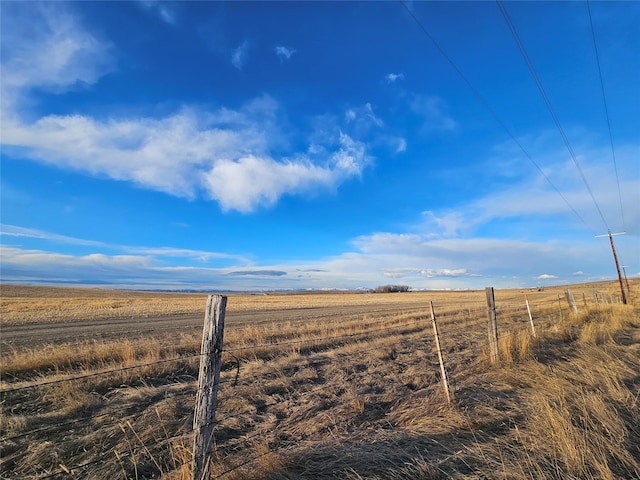 view of yard with a rural view and fence