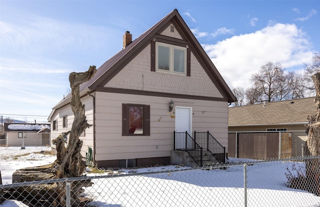 view of front of house with fence and a chimney