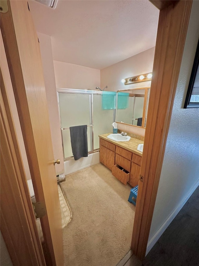 full bathroom featuring vanity and shower / bath combination with glass door