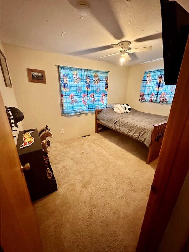 carpeted bedroom featuring a ceiling fan