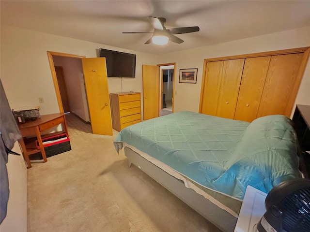 bedroom featuring a closet, light carpet, and ceiling fan