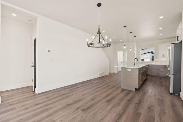 590 Stillwater Rd, Kalispell, MT 59901 - kitchen featuring freestanding refrigerator, an island with sink, wood finished floors, recessed lighting, and light countertops