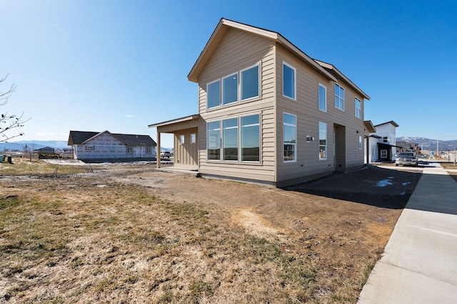 rear view of property with a mountain view