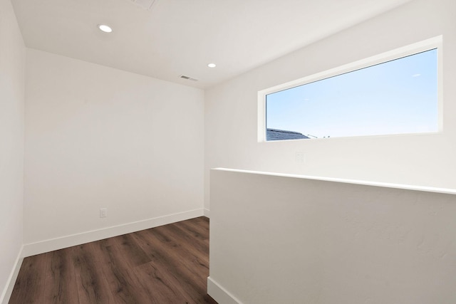 unfurnished room featuring recessed lighting, baseboards, visible vents, and dark wood-style flooring