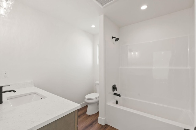 bathroom featuring recessed lighting, toilet, shower / bath combination, and wood finished floors