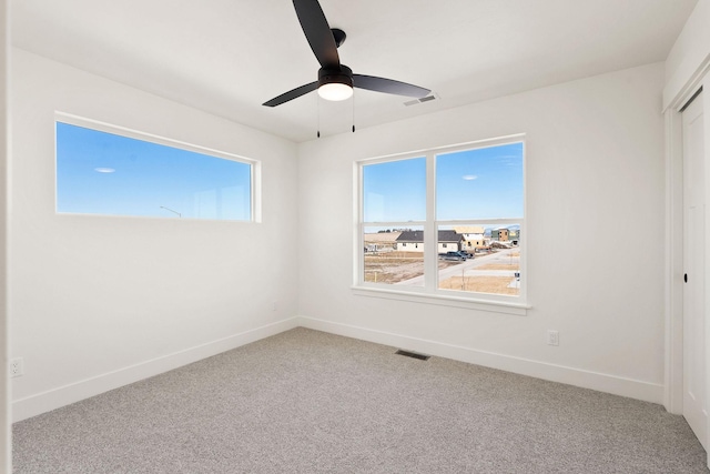 unfurnished bedroom with visible vents, baseboards, a closet, and carpet flooring